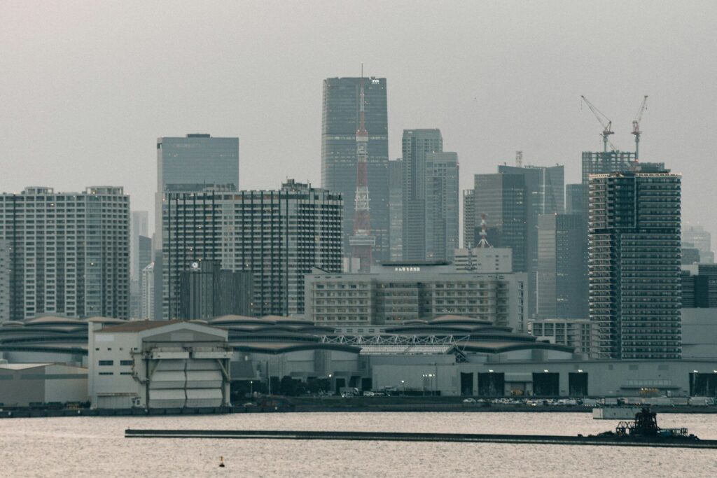 Modern cityscape with tall buildings and waterfront structures.